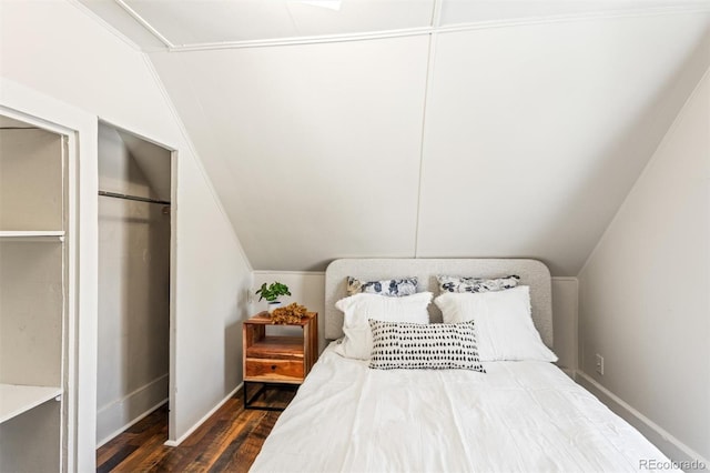 bedroom featuring lofted ceiling and dark hardwood / wood-style flooring