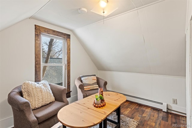 living area featuring a baseboard radiator, lofted ceiling, and dark hardwood / wood-style floors