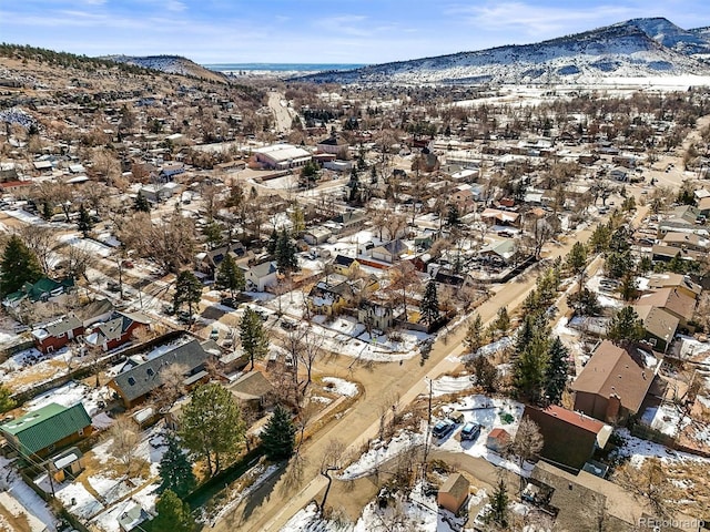 snowy aerial view featuring a mountain view