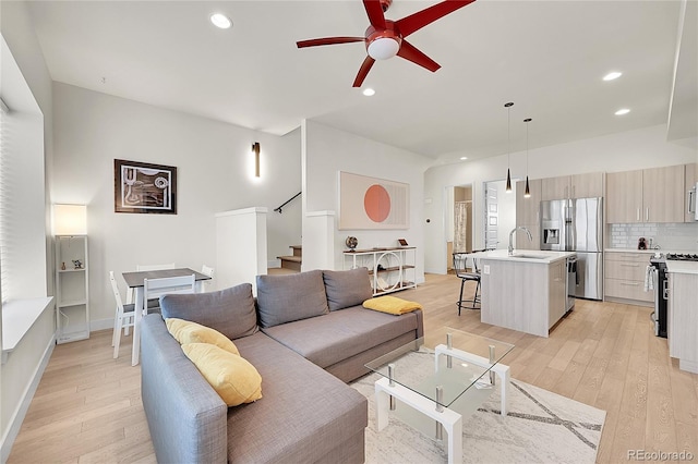 3044 Wilson Ct Unit 2, Denver, CO 80205 - living area featuring stairs, light wood-type flooring, ceiling fan, recessed lighting, and baseboards