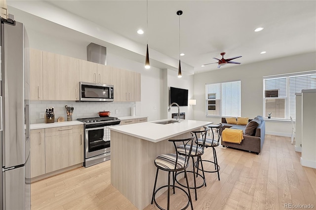 3044 Wilson Ct Unit 2, Denver, CO 80205 - kitchen with appliances with stainless steel finishes, a sink, open floor plan, modern cabinets, and recessed lighting