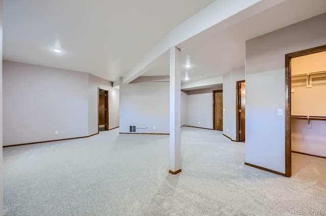 basement featuring light carpet