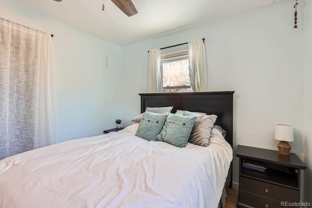 bedroom with ceiling fan and hardwood / wood-style floors