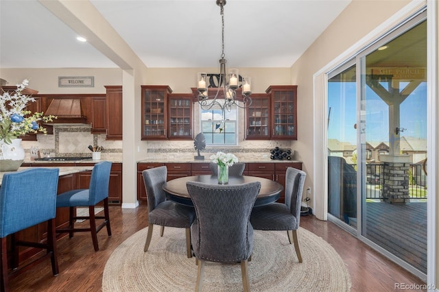 dining room featuring a notable chandelier and dark wood-style floors