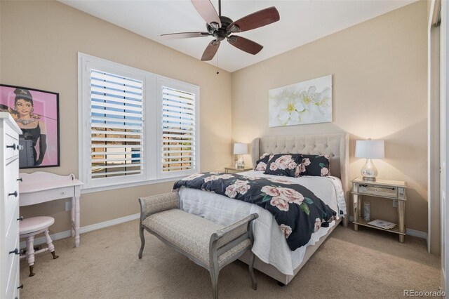 bedroom featuring baseboards, a ceiling fan, and carpet