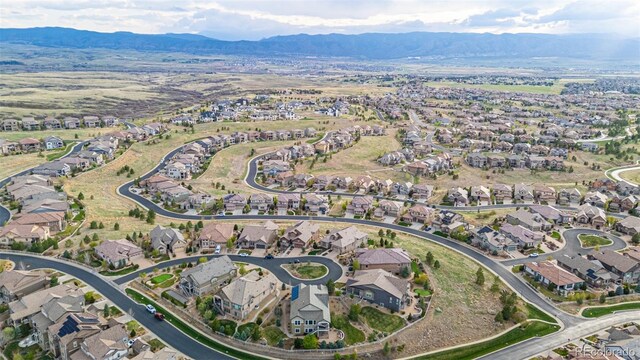 birds eye view of property with a mountain view and a residential view