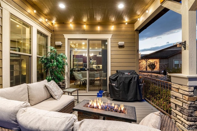view of patio / terrace with an outdoor living space with a fire pit, a grill, and a deck