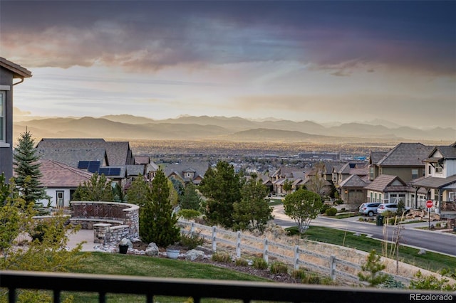 view of water feature with fence, a residential view, and a mountain view