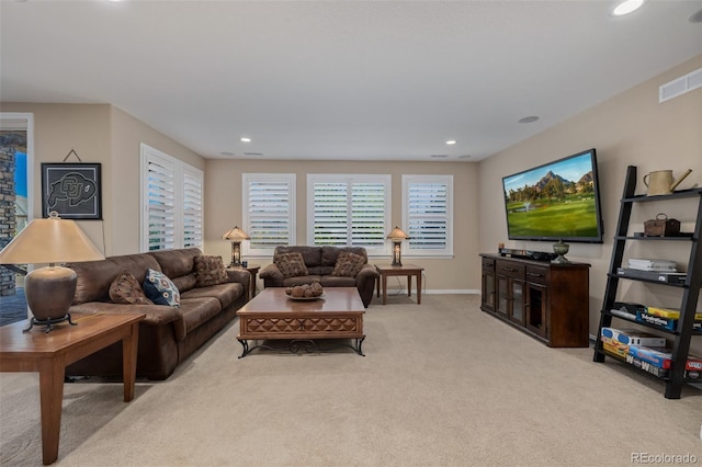 living area featuring baseboards, visible vents, recessed lighting, and light colored carpet
