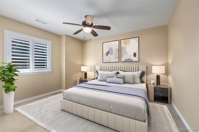 carpeted bedroom featuring visible vents, baseboards, and ceiling fan