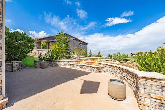 view of patio / terrace featuring an outdoor fire pit
