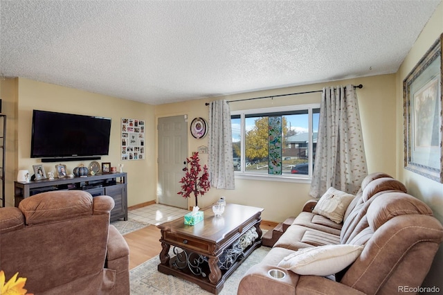 living room featuring a textured ceiling and light hardwood / wood-style flooring