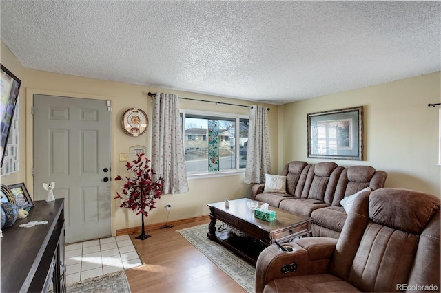 living room featuring a textured ceiling and light hardwood / wood-style flooring