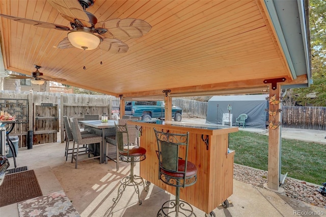 view of patio with ceiling fan and exterior bar