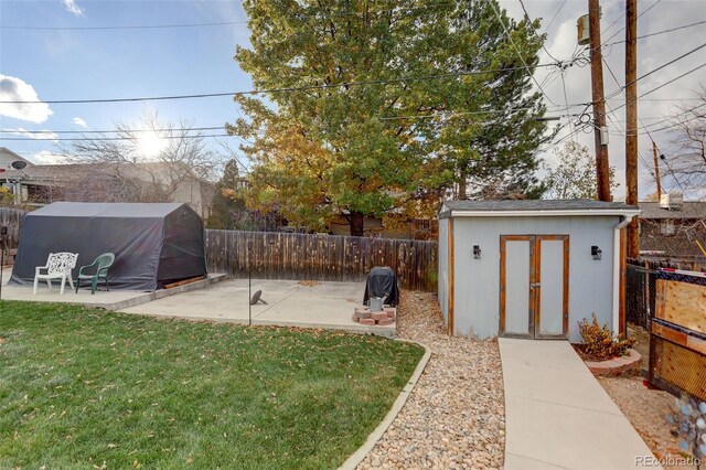 view of yard with a patio area and a storage shed