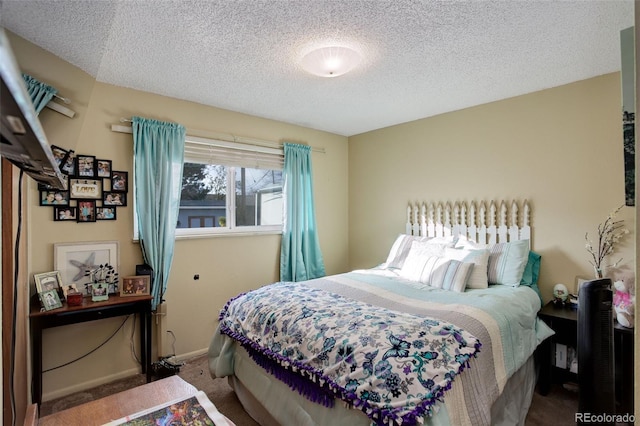 bedroom featuring carpet floors and a textured ceiling