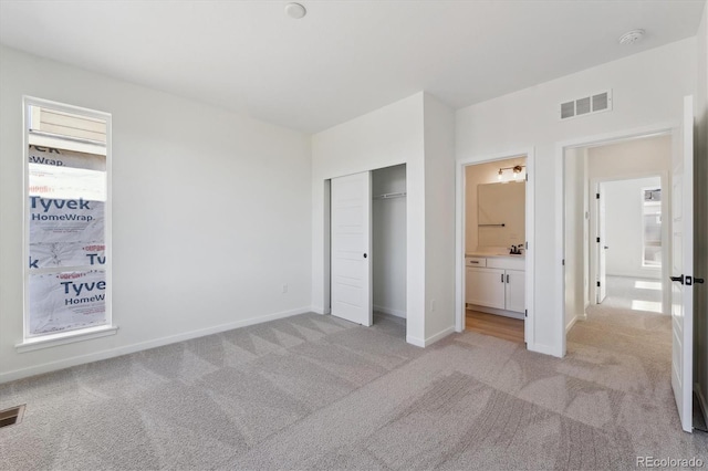 1243 Rhett Dr, Erie, CO 80026 - unfurnished bedroom featuring a sink, a closet, visible vents, baseboards, and light carpet