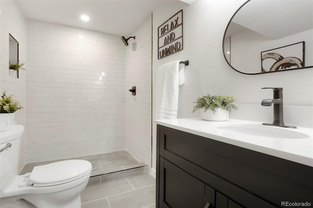 bathroom with tile patterned flooring, toilet, recessed lighting, a stall shower, and vanity