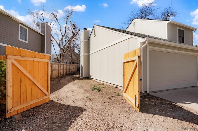 view of property exterior featuring fence and a shingled roof