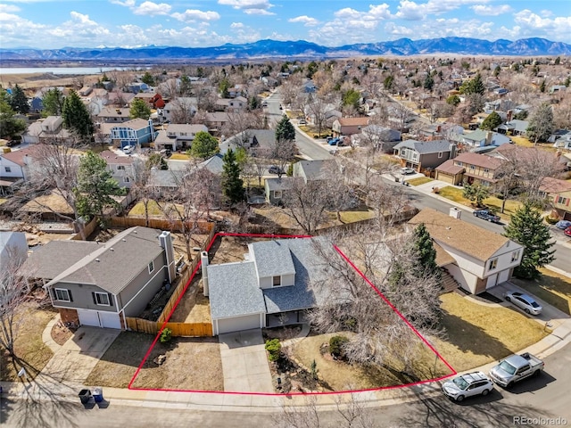 birds eye view of property with a mountain view and a residential view