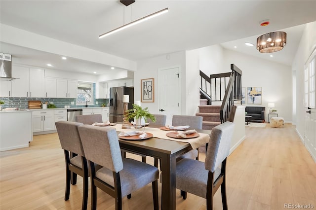 dining area with recessed lighting, stairway, and light wood-style floors