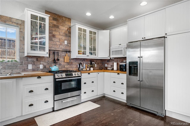 13349 Albion Cir, Thornton, CO 80241 - kitchen with stainless steel appliances, butcher block countertops, dark wood-type flooring, white cabinets, and glass insert cabinets