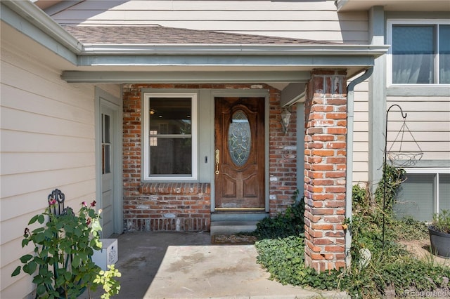 13349 Albion Cir, Thornton, CO 80241 - doorway to property featuring brick siding and roof with shingles