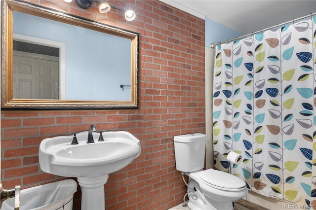 13349 Albion Cir, Thornton, CO 80241 - bathroom featuring brick wall and a shower with shower curtain
