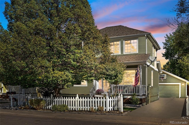 view of property hidden behind natural elements with a porch, a garage, and an outdoor structure