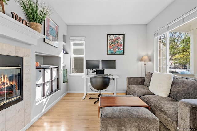 office space with light hardwood / wood-style floors and a fireplace