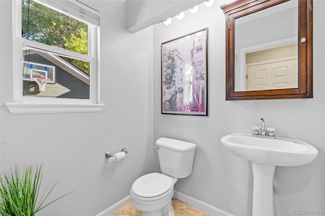 bathroom featuring tile patterned floors, toilet, and sink