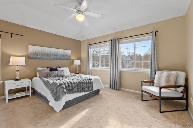 bedroom with ceiling fan and light colored carpet