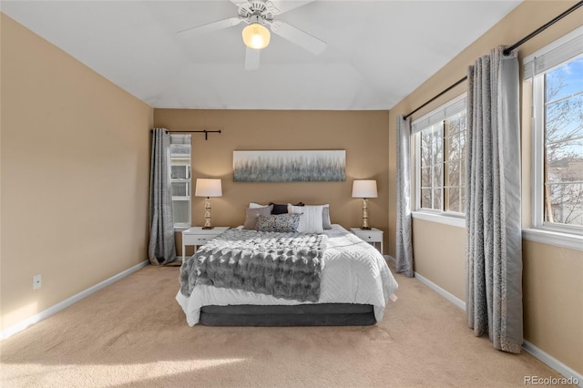 bedroom with ceiling fan and light carpet