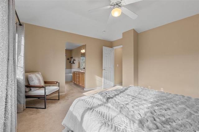 carpeted bedroom featuring ceiling fan and ensuite bathroom