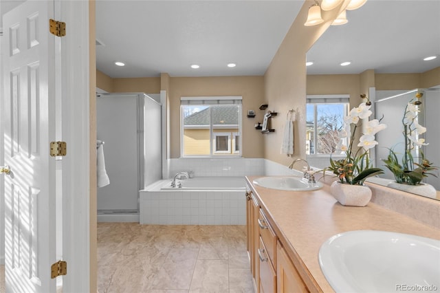 bathroom with vanity, tile patterned floors, plenty of natural light, and independent shower and bath