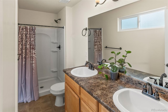 bathroom featuring a shower with curtain, vanity, toilet, and tile patterned floors