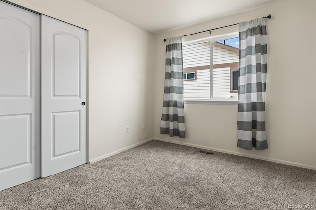 unfurnished bedroom with carpet flooring and a closet