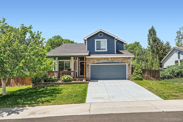 view of front of house with covered porch, fence, concrete driveway, stone siding, and a front lawn