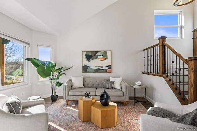 living area with plenty of natural light, baseboards, and wood finished floors