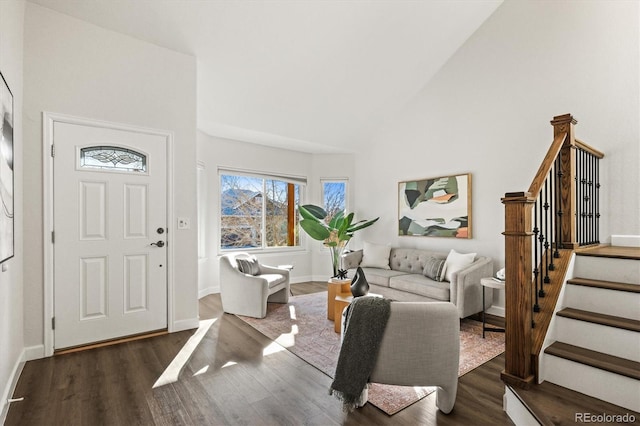 entryway with stairs, high vaulted ceiling, dark wood-style floors, and baseboards