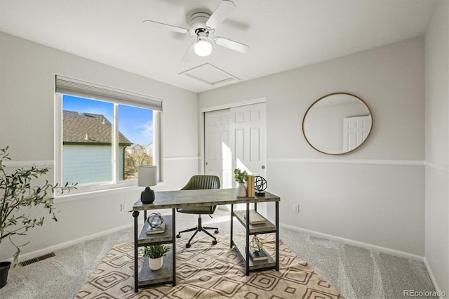 carpeted office space with attic access, visible vents, and baseboards