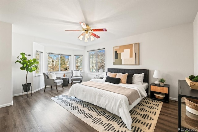 bedroom with a ceiling fan, baseboards, and wood finished floors