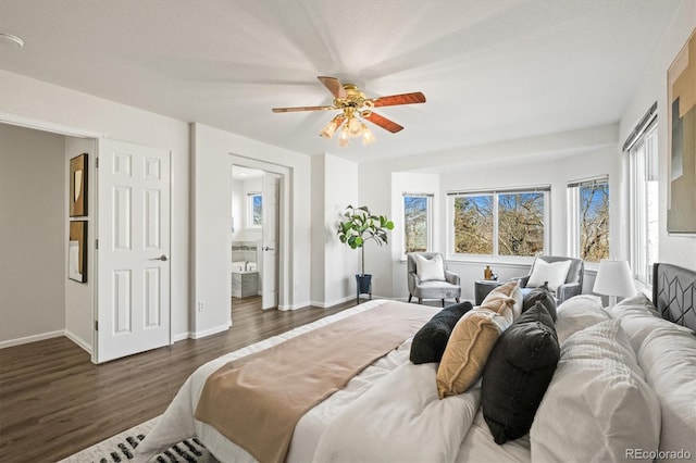 bedroom featuring ensuite bathroom, wood finished floors, a ceiling fan, and baseboards