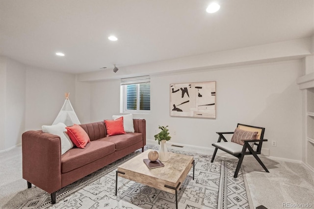 living area featuring recessed lighting, light carpet, and baseboards