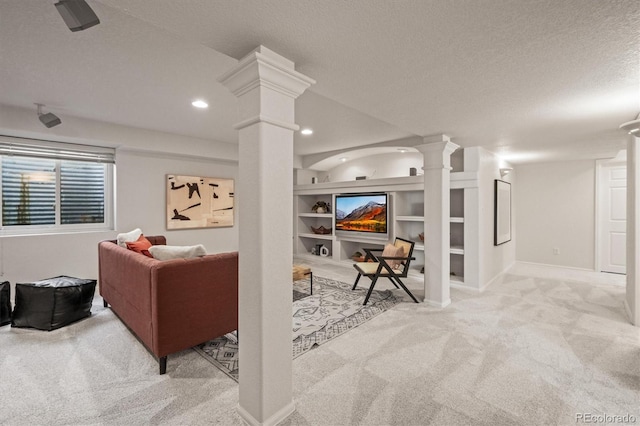 living room with a textured ceiling, recessed lighting, carpet floors, built in features, and ornate columns