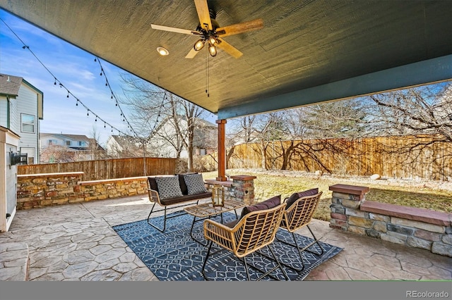 view of patio / terrace featuring a fenced backyard, an outdoor living space, and a ceiling fan