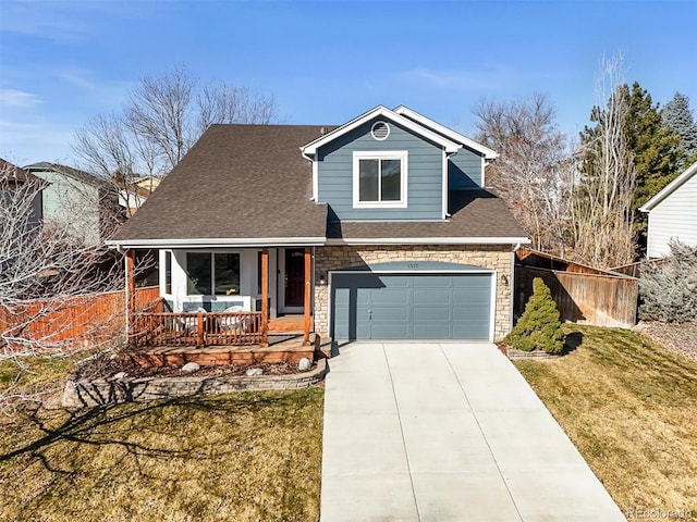 view of front of property featuring driveway, a shingled roof, stone siding, covered porch, and a front yard