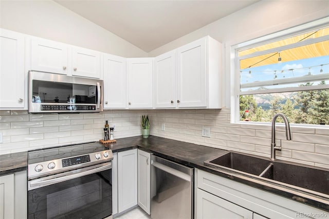 kitchen with stainless steel appliances, white cabinets, and sink