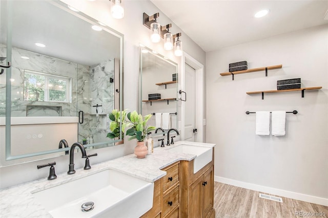 bathroom with walk in shower, wood-type flooring, and vanity