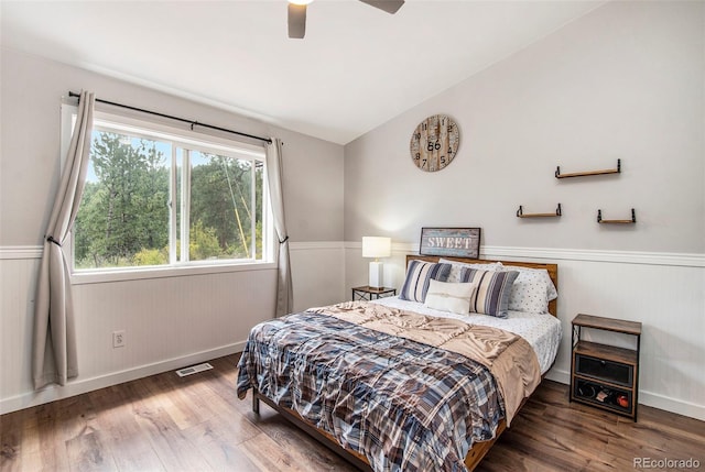 bedroom featuring ceiling fan, lofted ceiling, and hardwood / wood-style floors